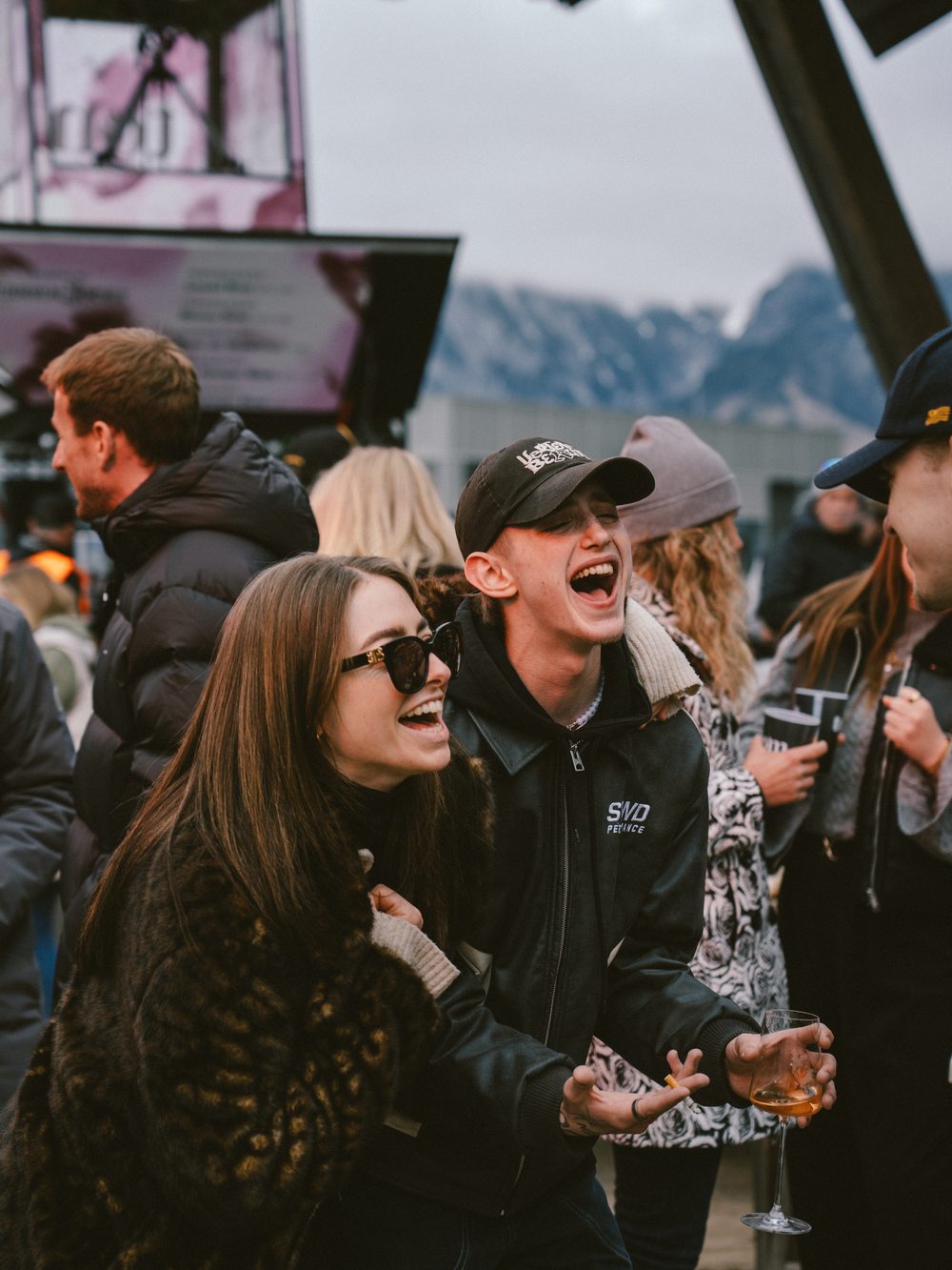 Friends laughing in the crowd at tom Almhütte